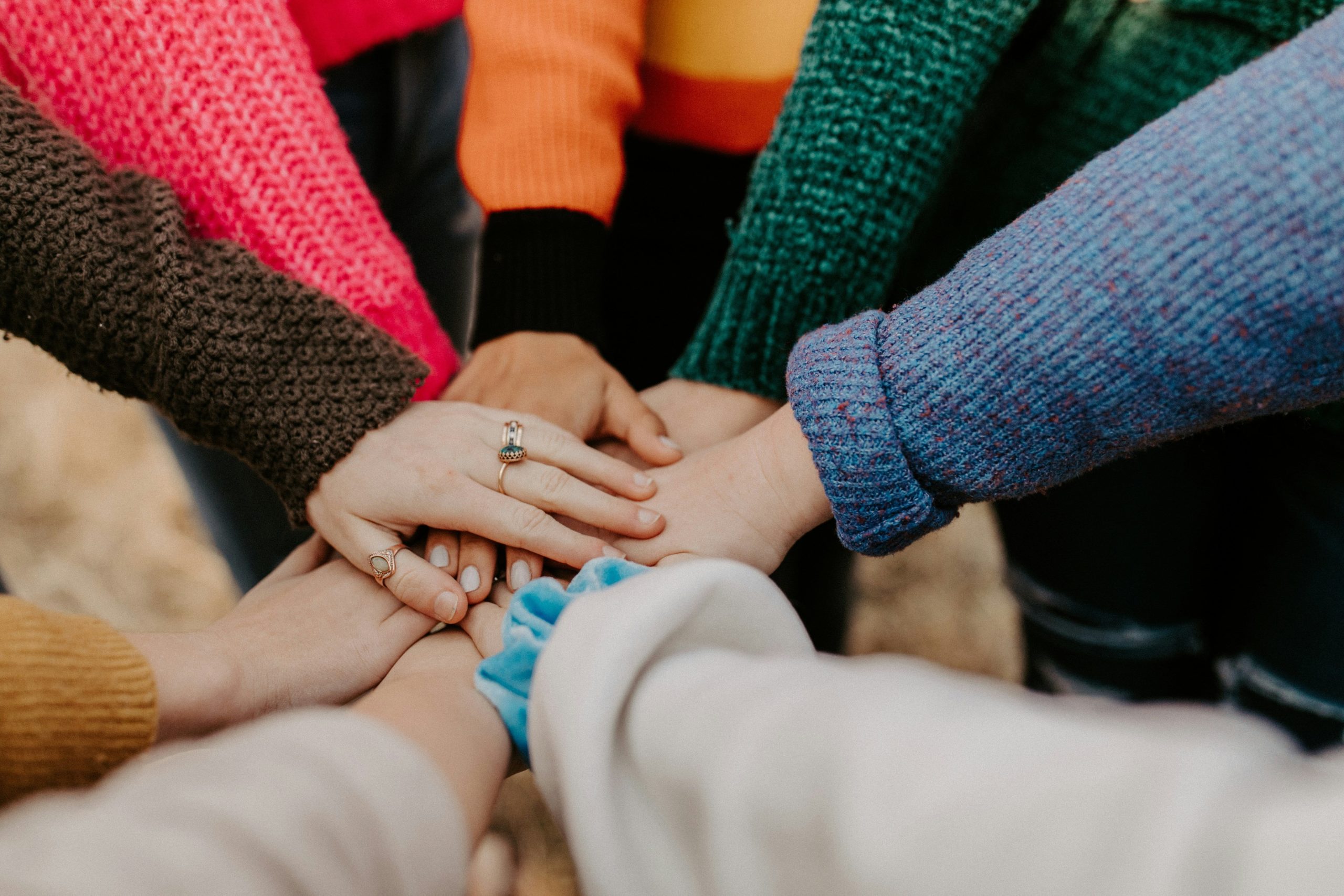 Kids hands in a huddle